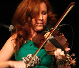 red-haired woman playing fiddle