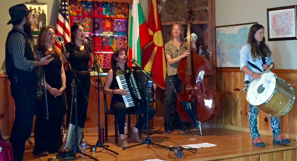 five people playing musical instruments on stage