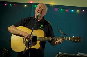 An older man playing a guitar