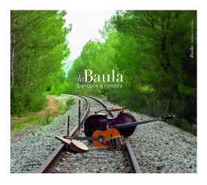 cover, Cançons a l’Ombra: musical instruments laid on railroad tracks through a forest