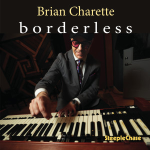 cover, Borderless: a man in a suit playing a huge keyboard
